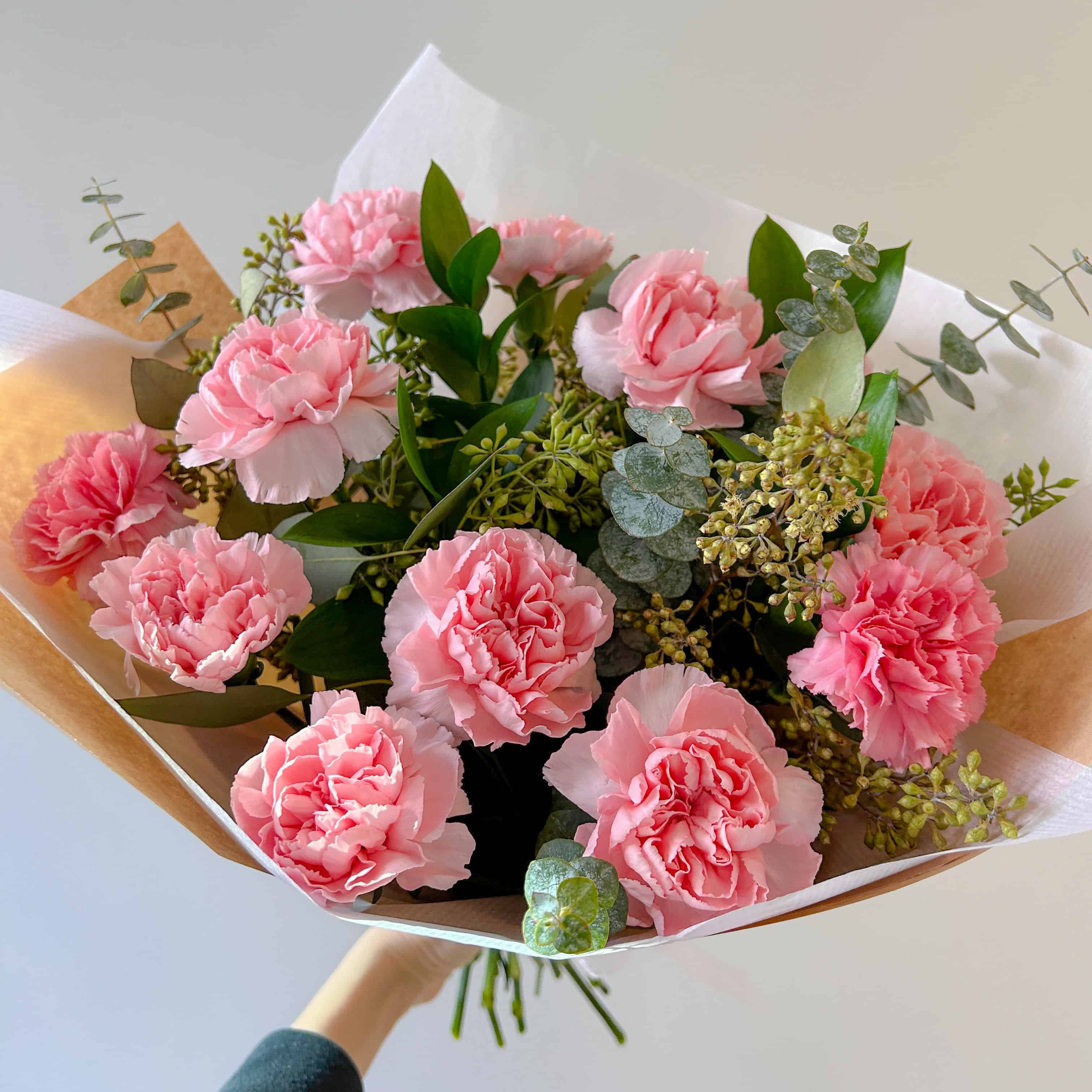 pink carnations and seeded eucalyptus in a centrepiece of style